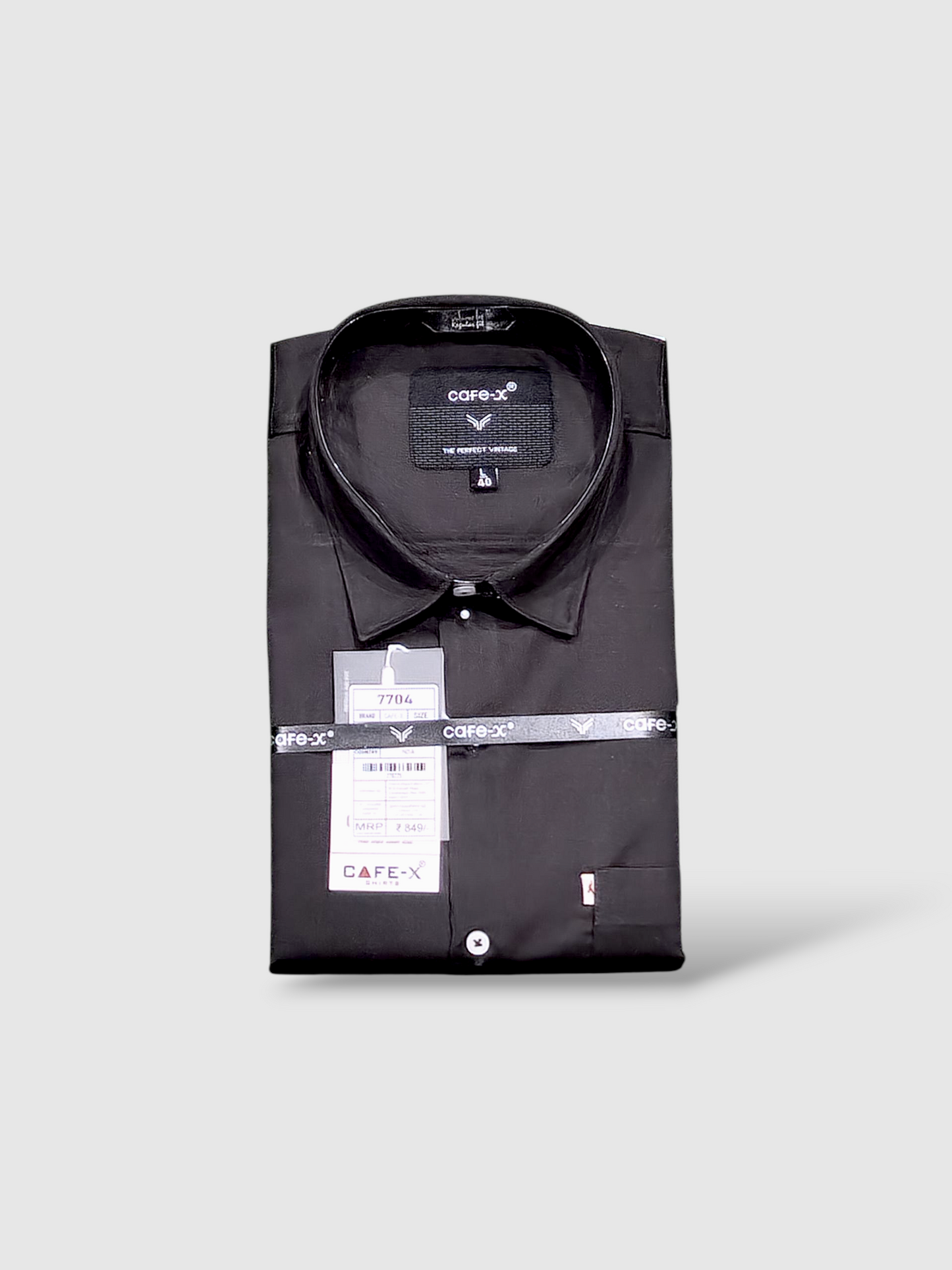 Folded black shirt with a cafe-x label on a light gray background