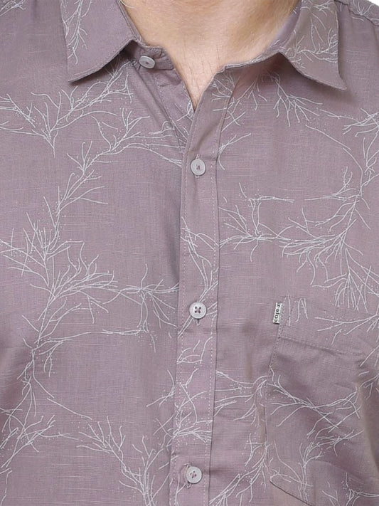 Close-up of a brown shirt with white floral pattern