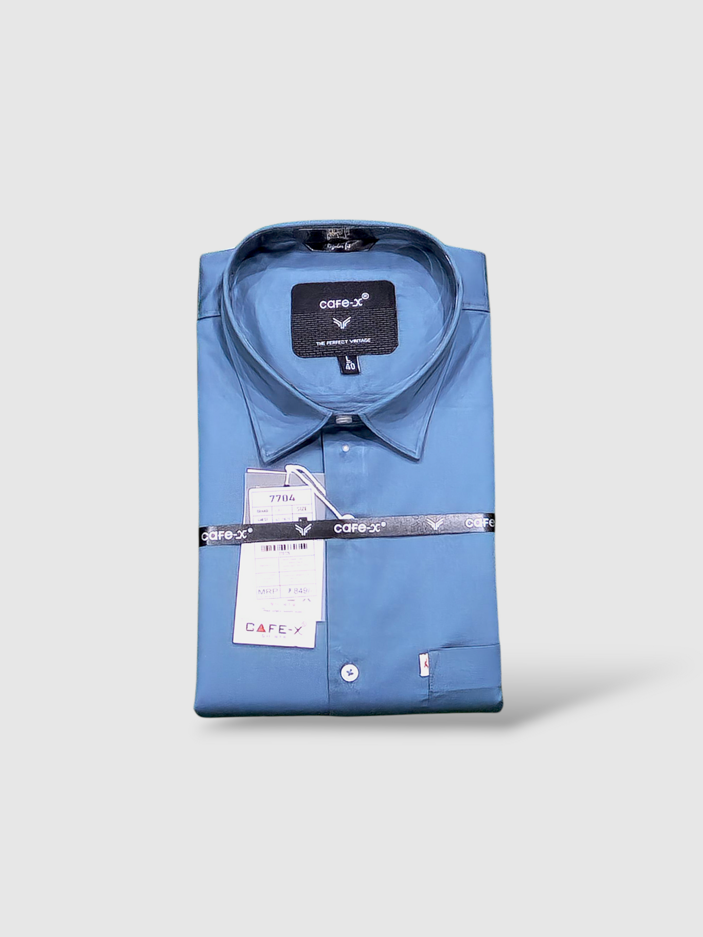 Folded blue shirt with Cafe-x label on a light gray background