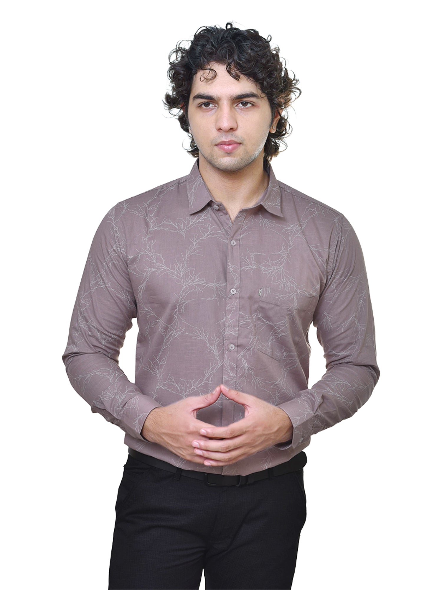 Man wearing a patterned brown shirt on a white background