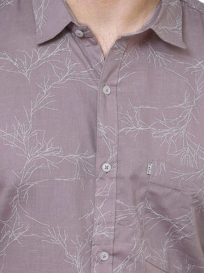 Close-up of a brown shirt with white floral pattern